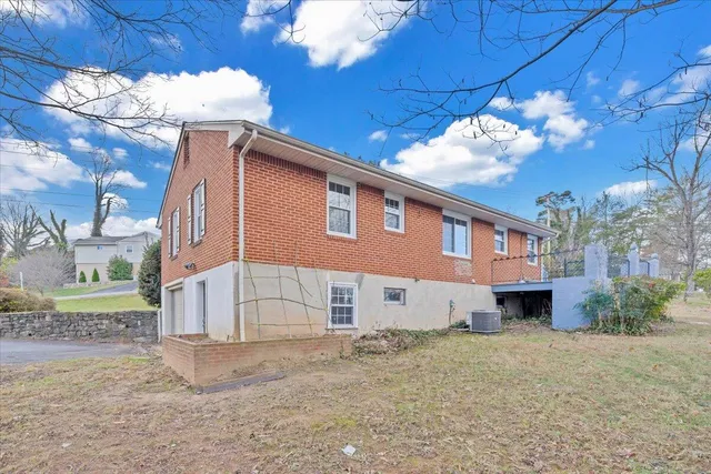 a view of a house with a yard and pathway