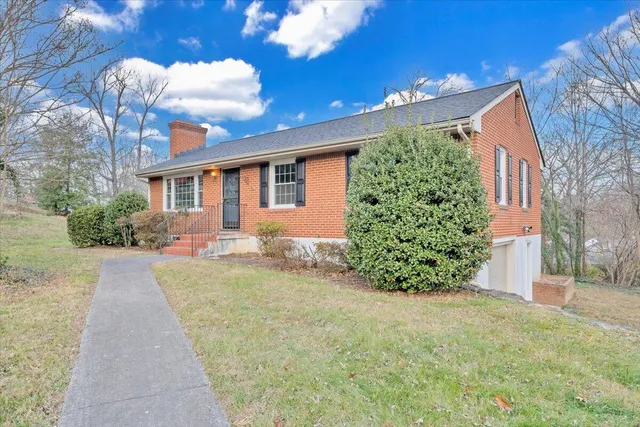 a front view of a house with a yard and seating space