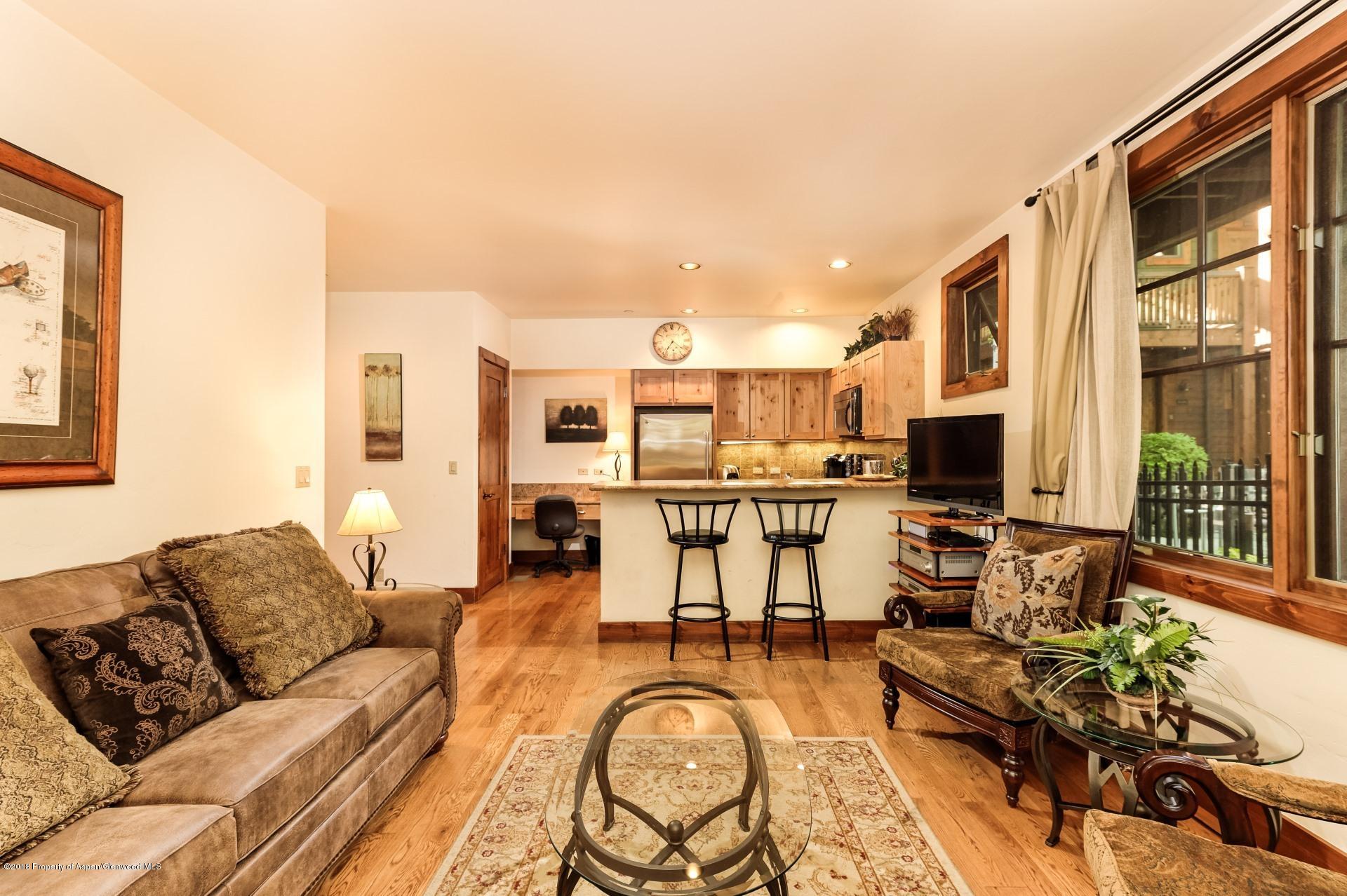 501 West Main Street, Unit A106 Aspen, CO 81611 - Photo 3 of 13 a living room with furniture and a floor to ceiling window