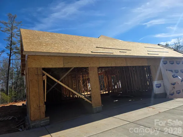 a view of a pathway with a wrought fence