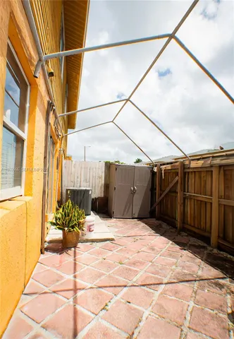 a view of empty room with floor to ceiling windows