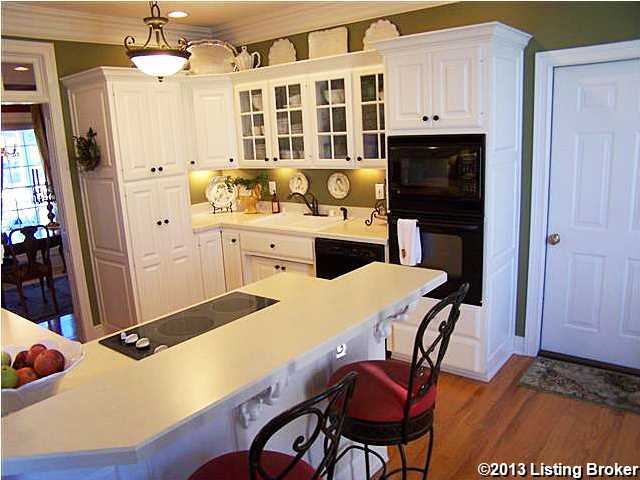 3530 Samuels Road Coxs Creek, KY 40013 - Photo 19 of 30 Spacious Eat-in Kitchen with a vaulted ceiling Eat-In Area (show in another picture), lots of custom made cabinets, pantry with pull out shelving, double oven set up (one is microwave now), under counter lighting, crown molding & gleaming hardwood floors.