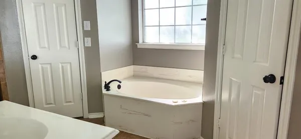 a bathroom with shower and bathtub