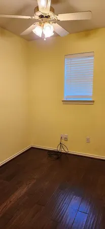 a view of a room with wooden floor and a window