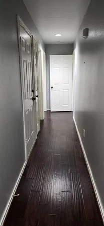 wooden floor in an empty room with a mirror