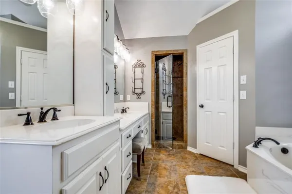 a bathroom with a tub sink and mirror