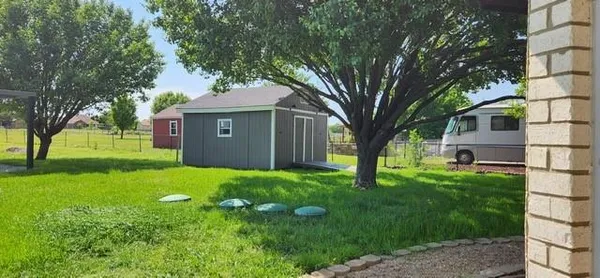 a view of a house with backyard and sitting area