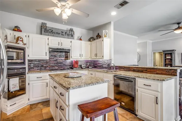 a kitchen with stainless steel appliances granite countertop a sink stove and cabinets