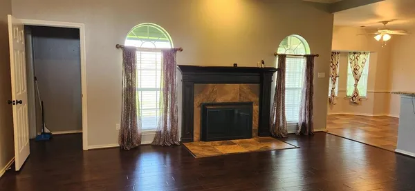 a view of a hallway with wooden floor and stairs