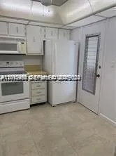 a view of an empty room with a cabinet