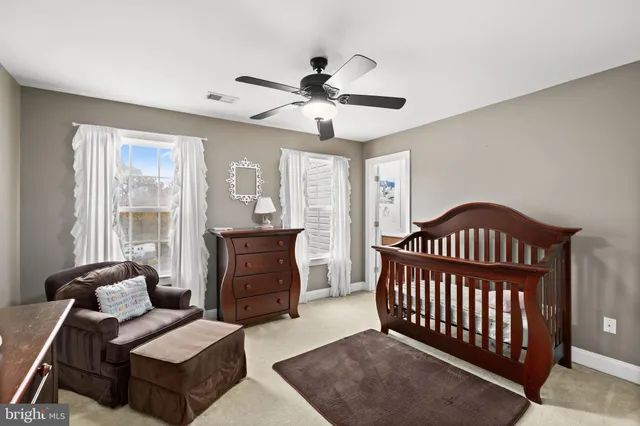 a bedroom with a bed a window and a flat screen television