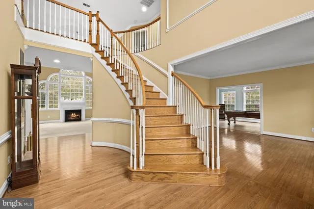 a kitchen with a stove a sink a counter top space and living room view