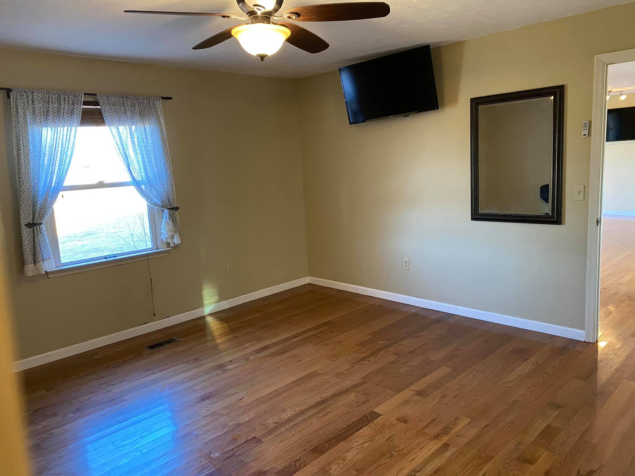 3440 Vesta Road Lebanon, TN 37090 - Photo 8 of 37 a view of an empty room with wooden floor and a window
