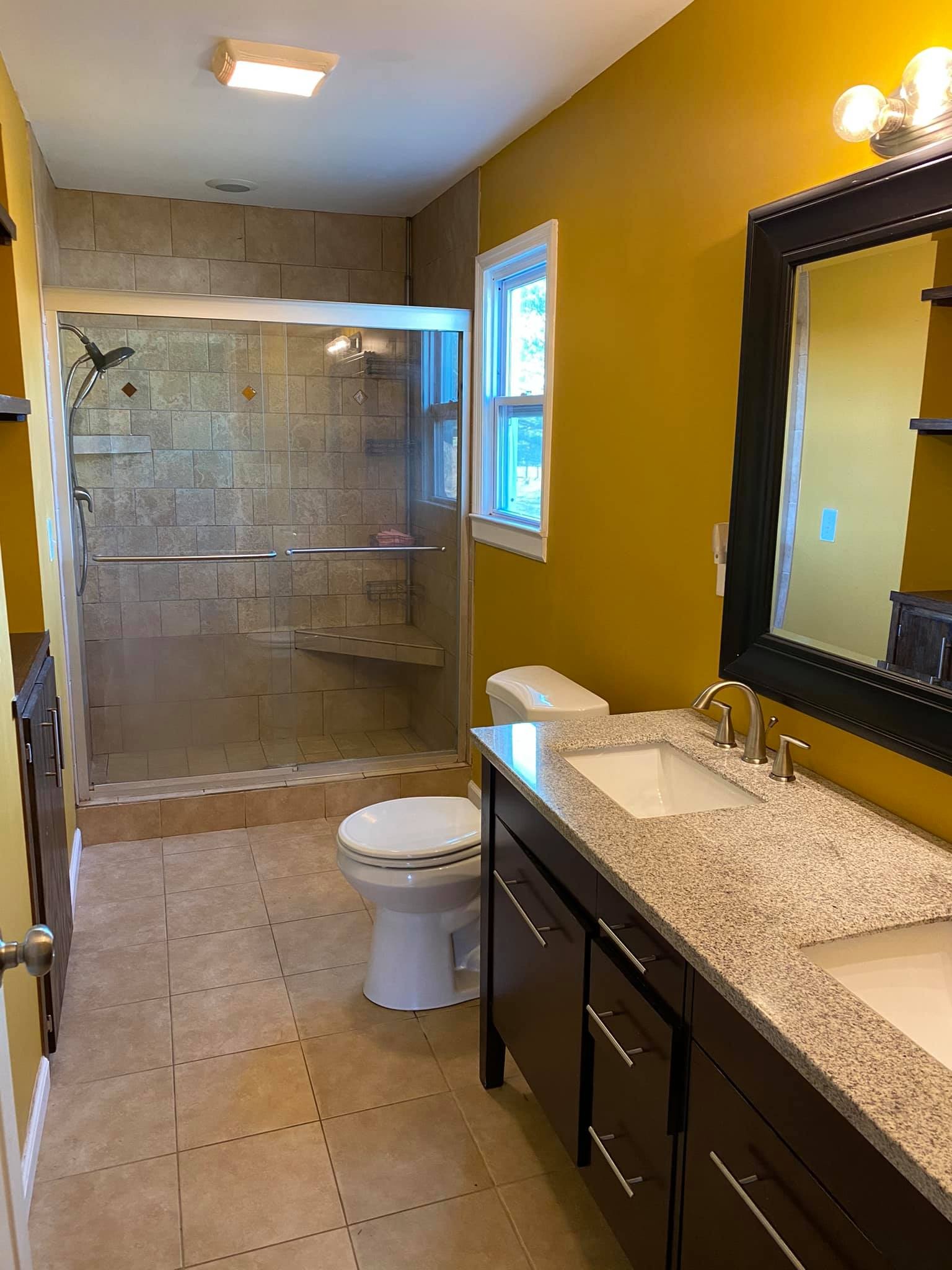 3440 Vesta Road Lebanon, TN 37090 - Photo 9 of 37 a bathroom with a granite countertop sink a toilet a mirror and shower