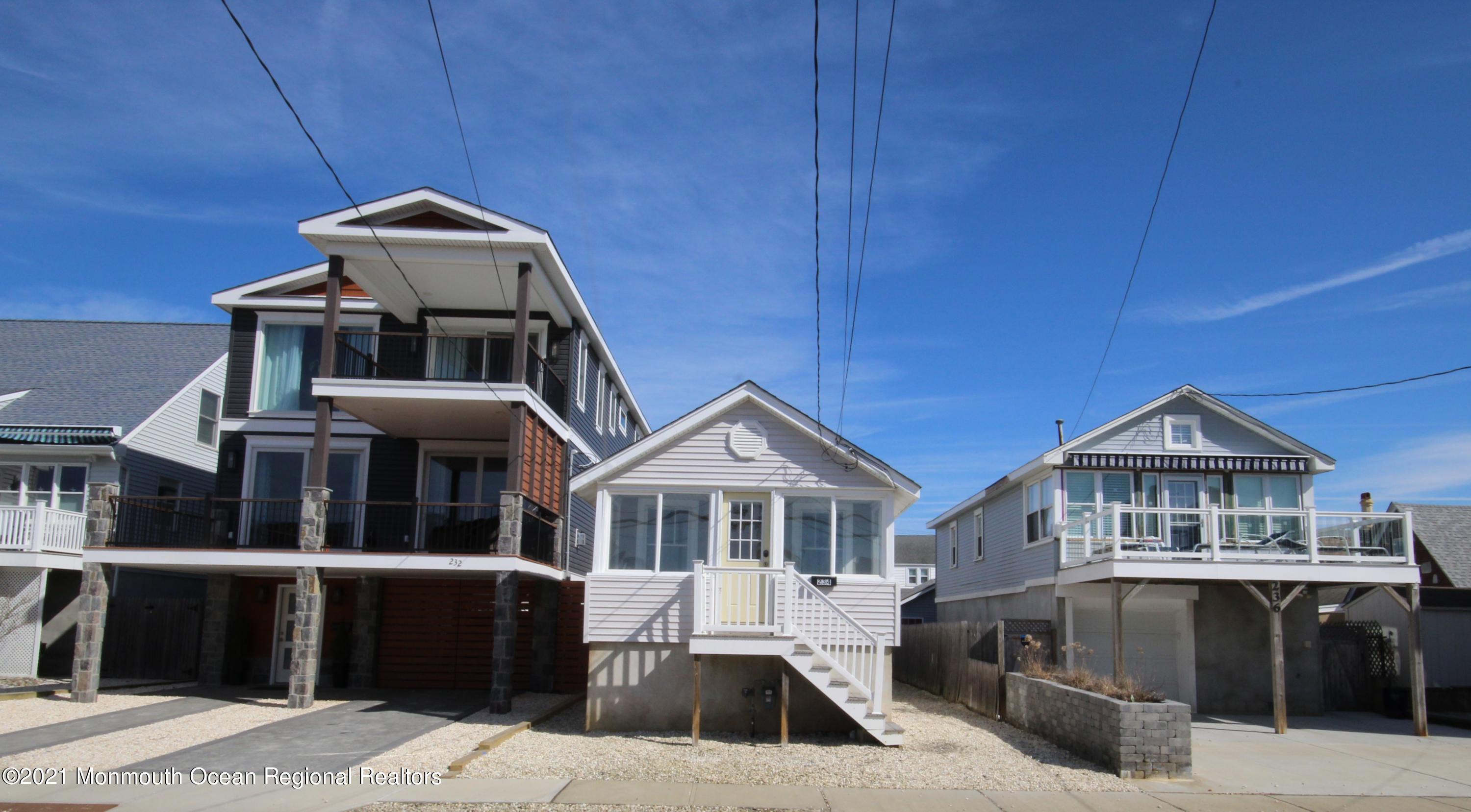234 4th Avenue Manasquan, NJ 08736 - Photo 2 of 13 a front view of a house with a yard