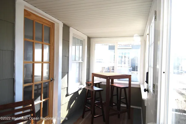 a room with wooden furniture and windows