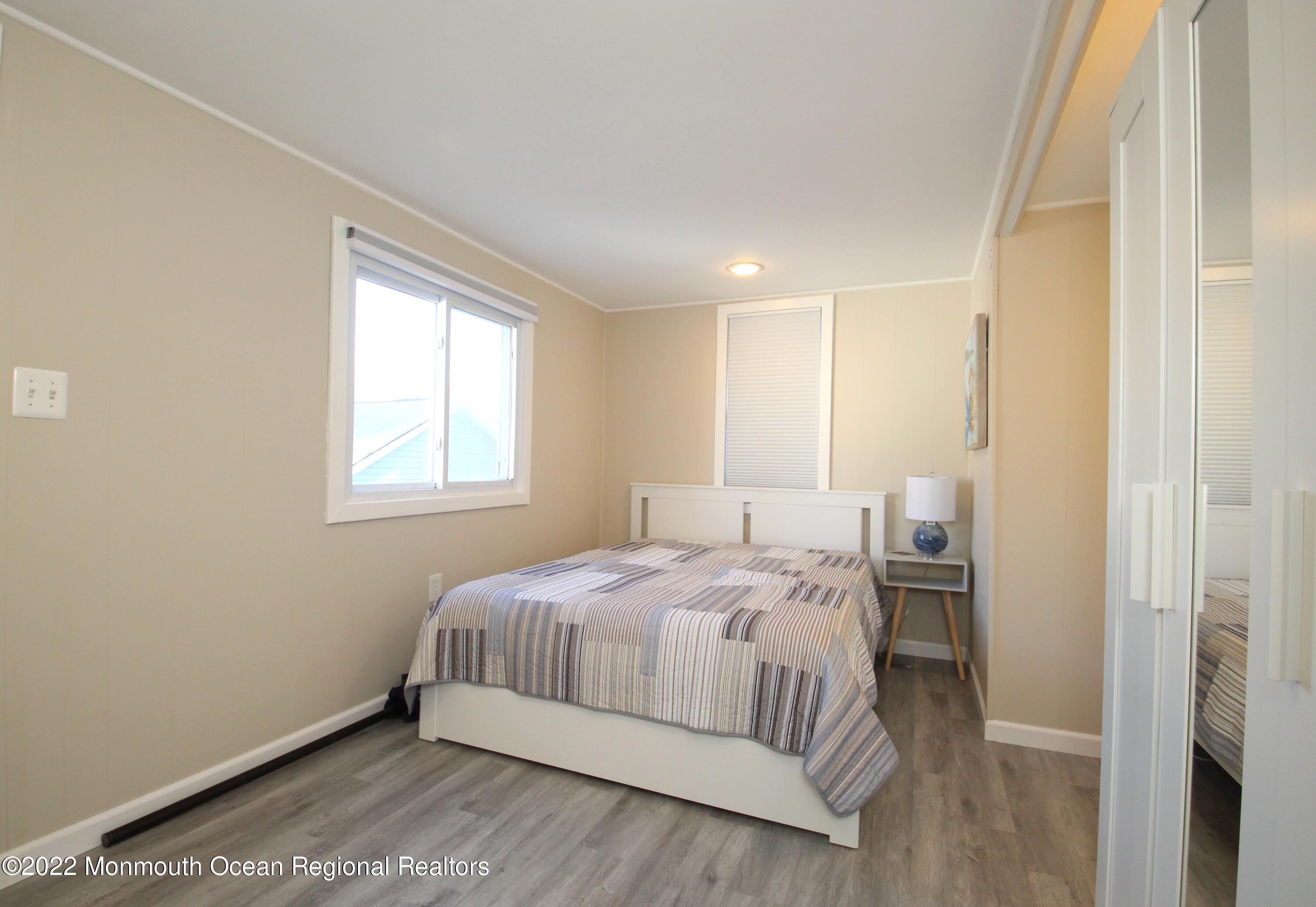 234 4th Avenue Manasquan, NJ 08736 - Photo 8 of 13 a bedroom with a bed and window