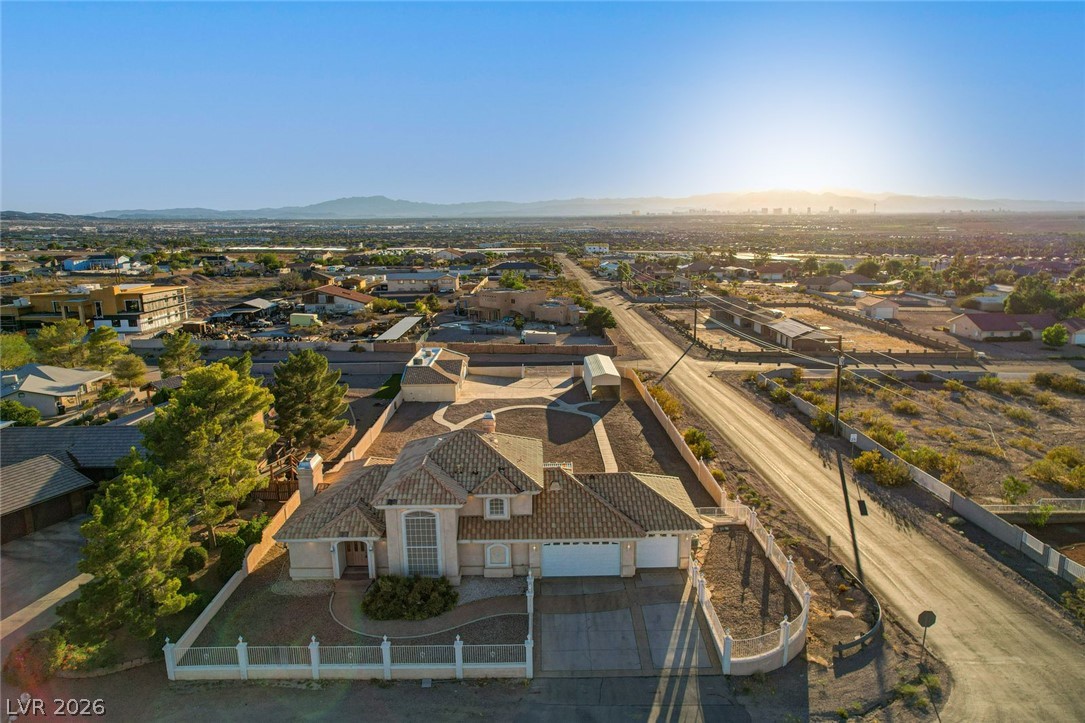 640 North Racetrack Road Henderson, NV 89015 - Photo 55 of 65 An aerial perspective reveals a private residence nestled amidst a vibrant desert landscape under a clear sky.