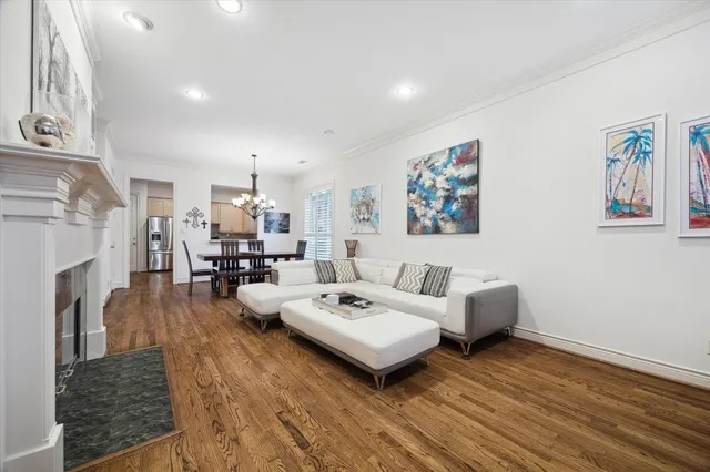 a living room with fireplace furniture and a wooden floor