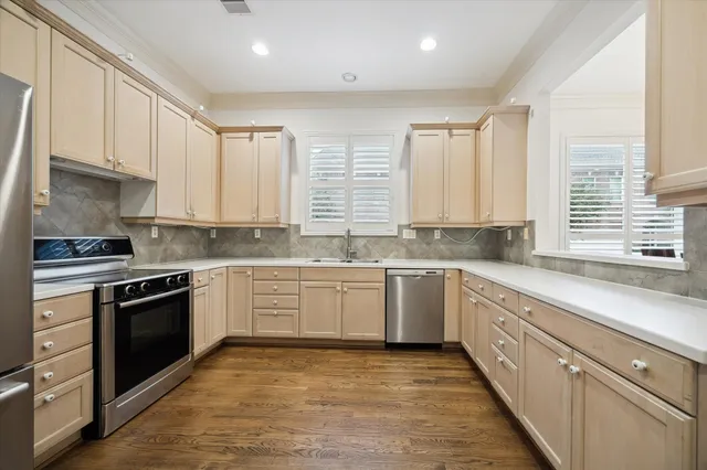 a large kitchen with stainless steel appliances granite countertop a stove and a sink