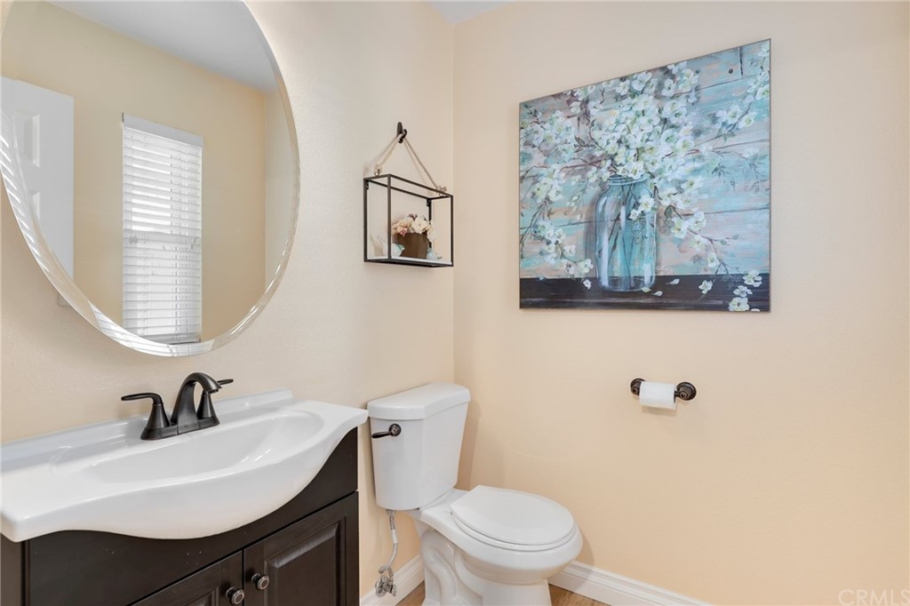 14 Wintermist, Unit 83 Irvine, CA 92614 - Photo 24 of 45 a bathroom with a toilet a sink and mirror