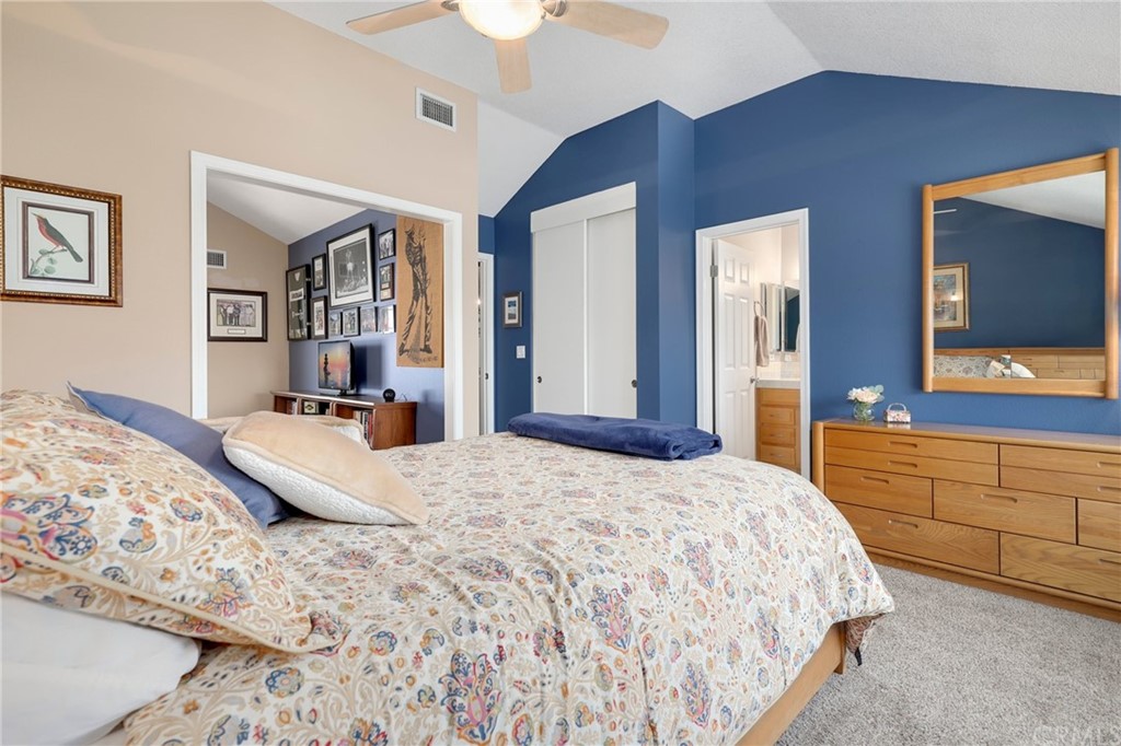 14 Wintermist, Unit 83 Irvine, CA 92614 - Photo 31 of 45 a bedroom with a large bed and a flat screen tv