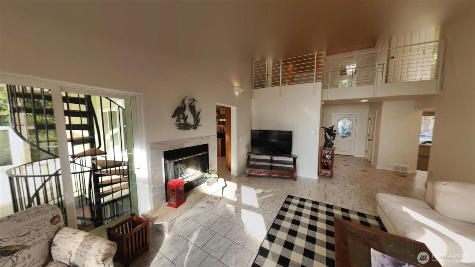 10405 Samish Island Road Bow, WA 98232 - Photo 19 of 38 a living room with furniture a flat screen tv and a fireplace