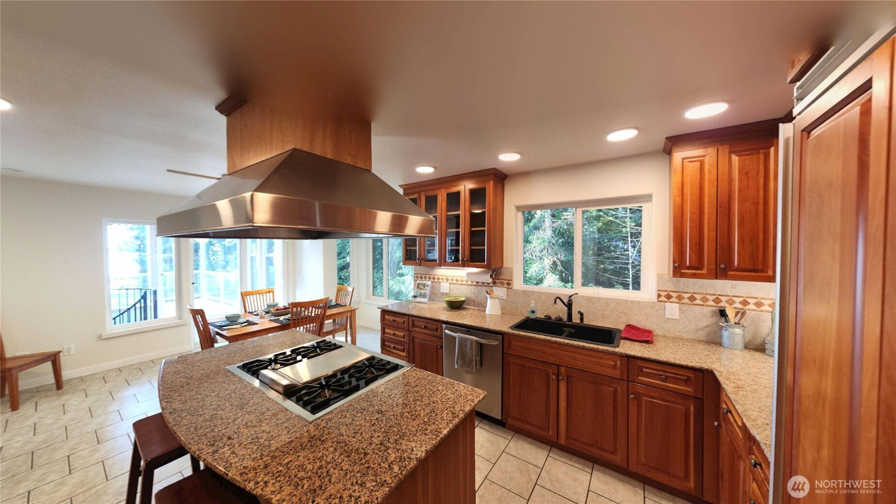 10405 Samish Island Road Bow, WA 98232 - Photo 23 of 38 a kitchen with granite countertop sink stove and dining table