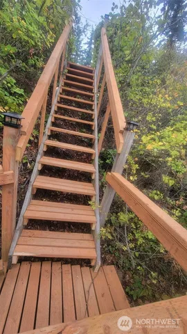 a view of balcony with wooden floor and fence