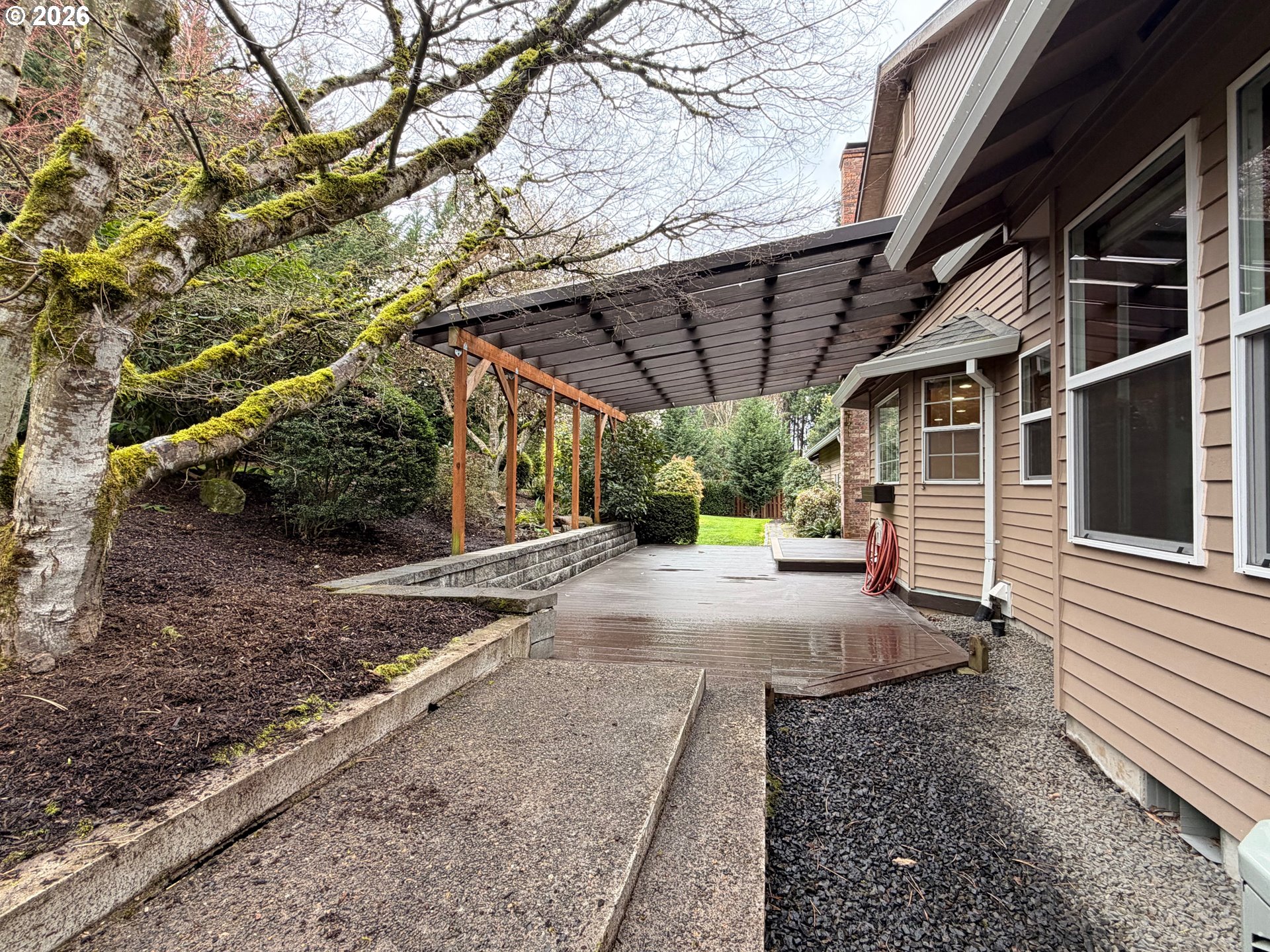 7505 Southwest Schroeder Way Wilsonville, OR 97070 - Photo 18 of 24 a view of a backyard with table and chairs and wooden fence