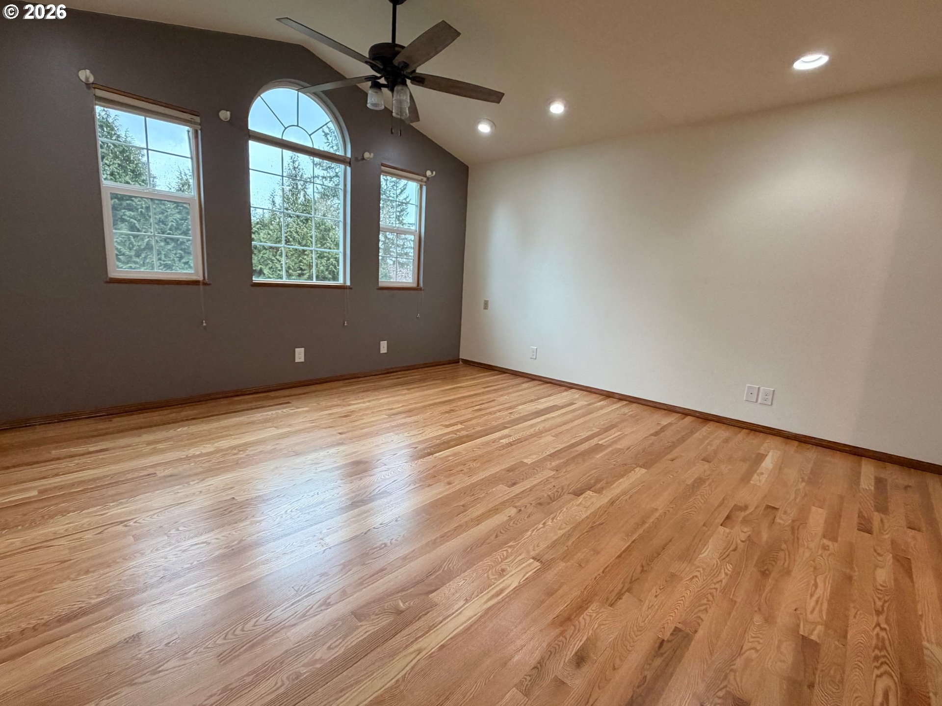 7505 Southwest Schroeder Way Wilsonville, OR 97070 - Photo 22 of 24 an empty room with wooden floor windows and fan