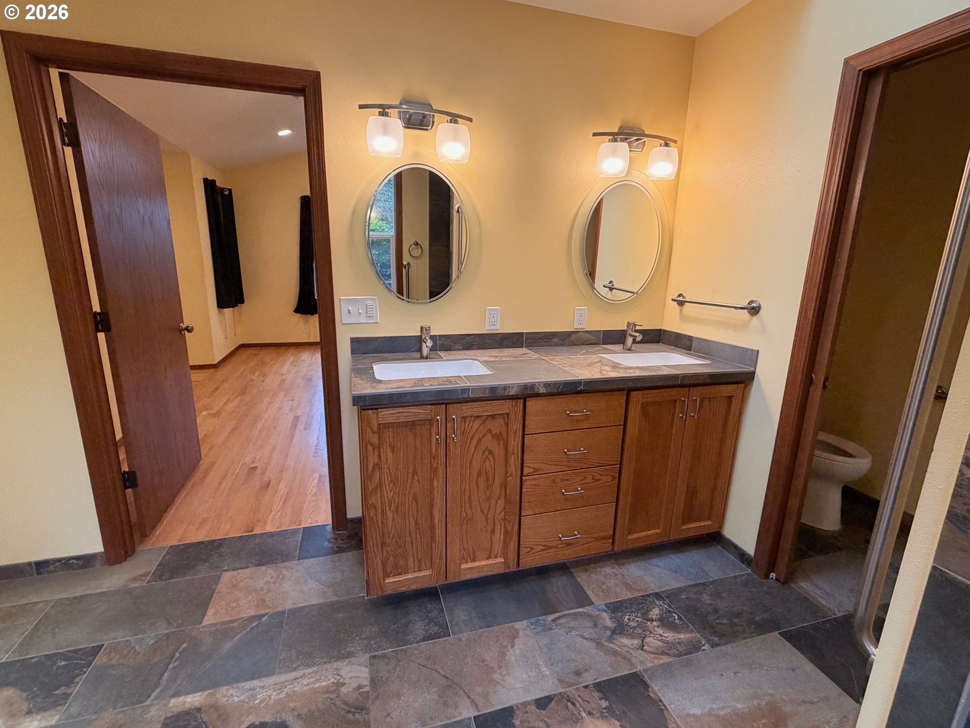 7505 Southwest Schroeder Way Wilsonville, OR 97070 - Photo 9 of 24 a bathroom with a double vanity sink and mirror