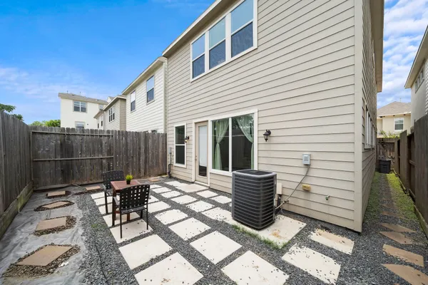 a view of a chairs and table in backyard