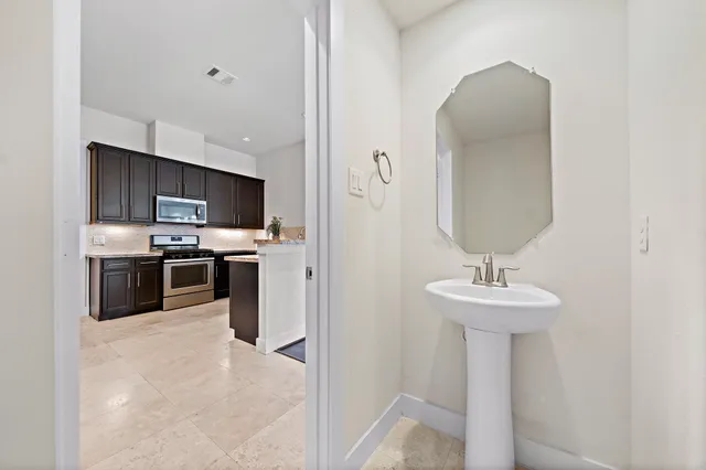 a kitchen with stainless steel appliances a sink stove and refrigerator