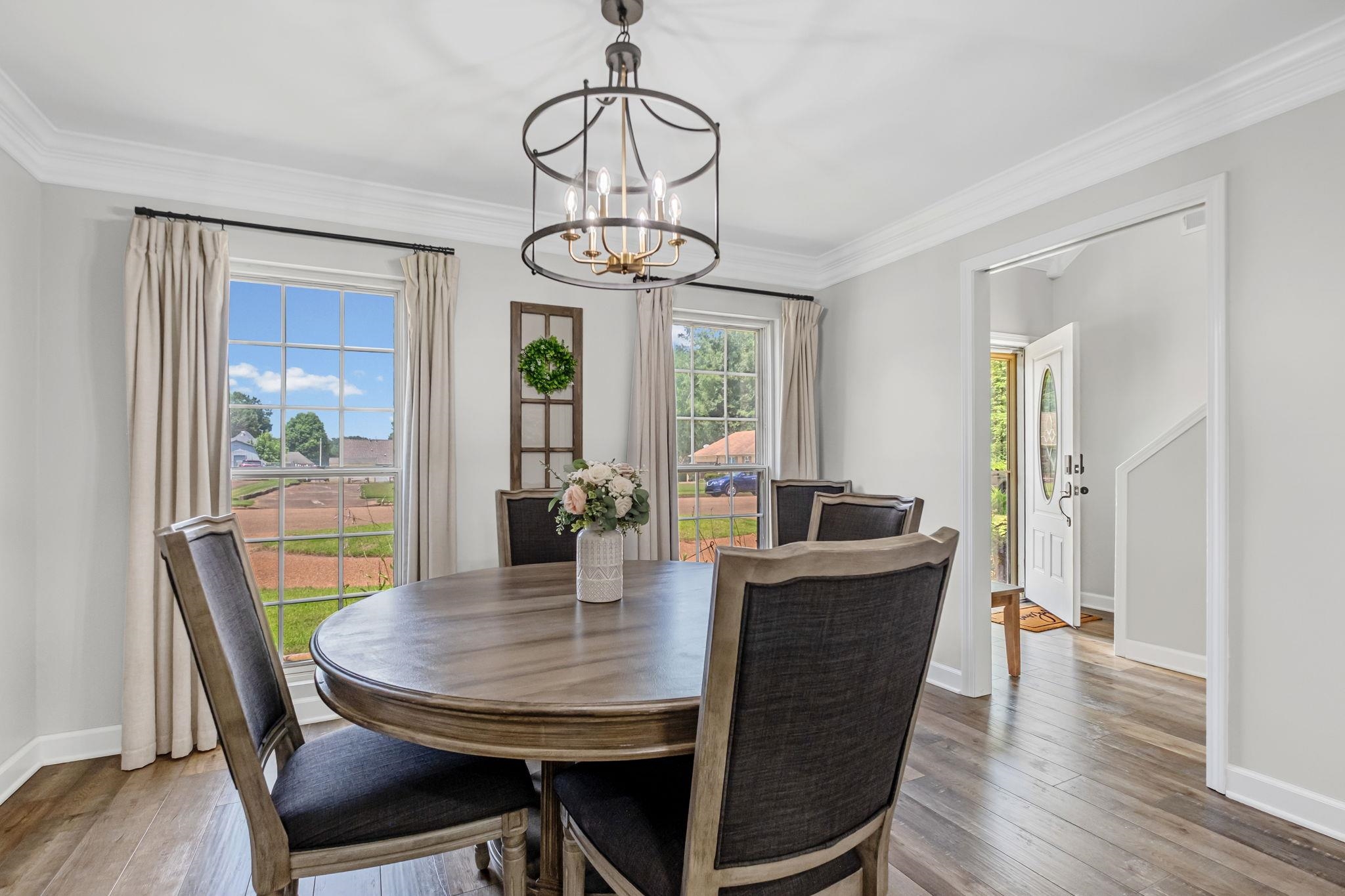 4729 Cedar Ridge Drive Millington, TN 38053 - Photo 16 of 40 Dining space featuring wood-finish flooring, two large windows, and an ornate ceiling fixture