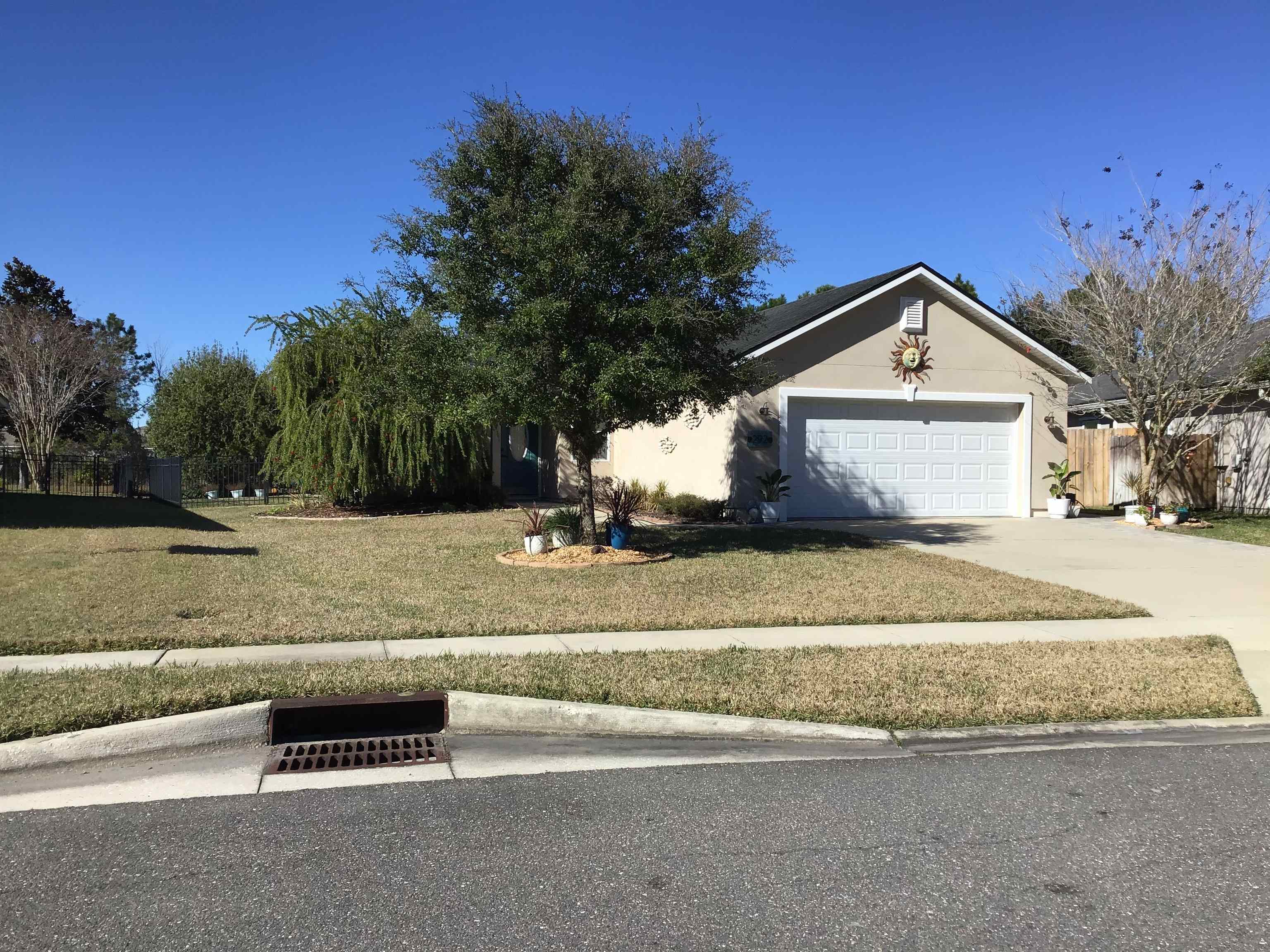 292 North Twin Maple Road St. Augustine, FL 32084 - Photo 2 of 79 a front view of a house with a yard