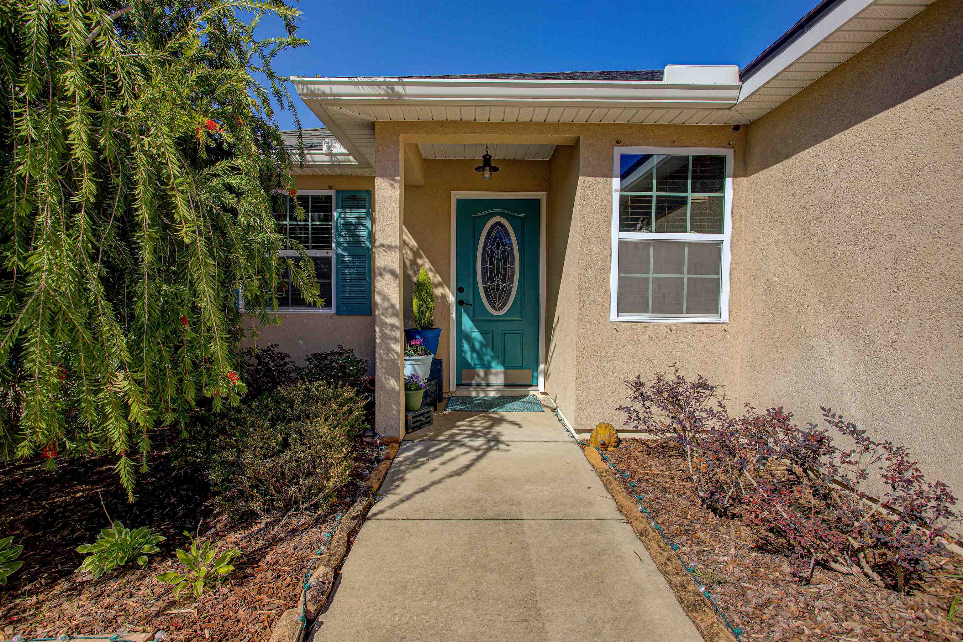 292 North Twin Maple Road St. Augustine, FL 32084 - Photo 20 of 79 View of exterior entry featuring stucco siding