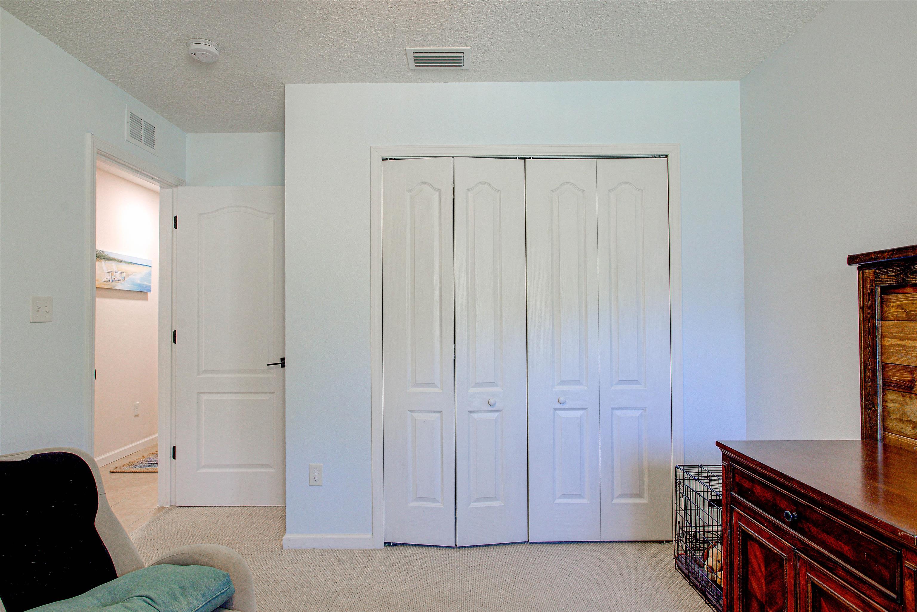 292 North Twin Maple Road St. Augustine, FL 32084 - Photo 37 of 79 Bedroom featuring light colored carpet, a textured ceiling, and a closet