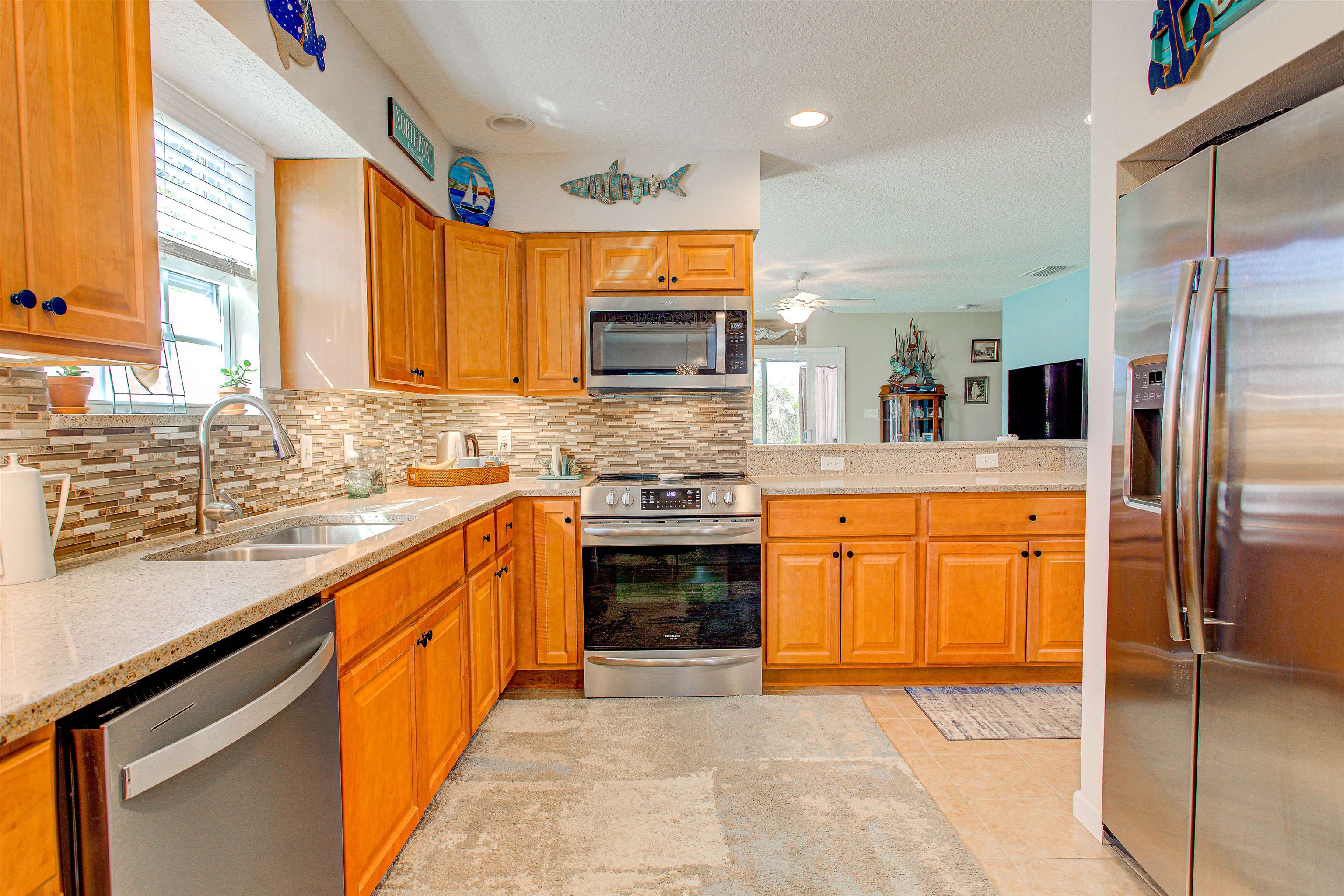 292 North Twin Maple Road St. Augustine, FL 32084 - Photo 42 of 79 a kitchen with stainless steel appliances granite countertop a stove top oven a sink and a refrigerator