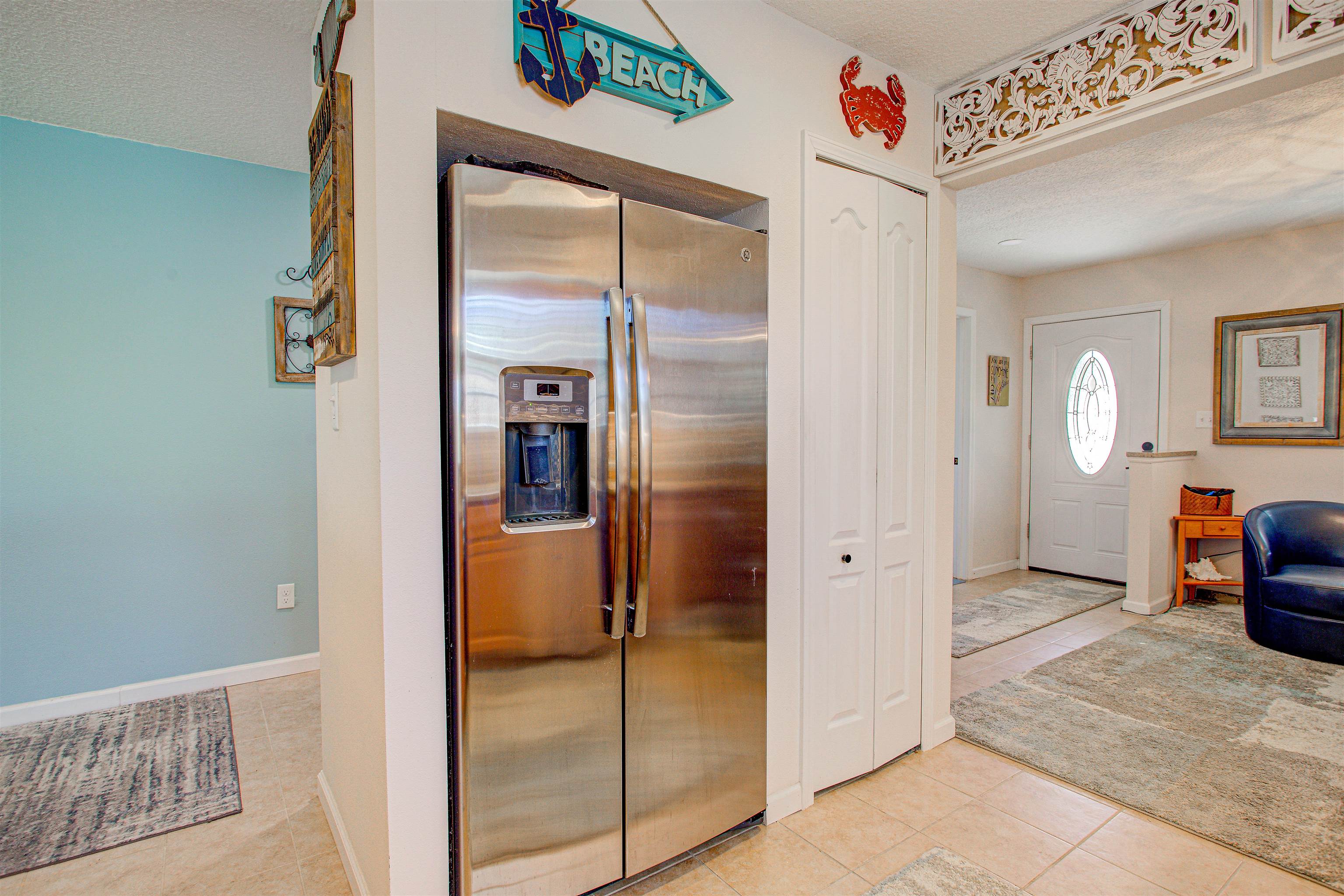 292 North Twin Maple Road St. Augustine, FL 32084 - Photo 45 of 79 Kitchen featuring stainless steel refrigerator with ice dispenser, a textured ceiling, and light tile patterned floors