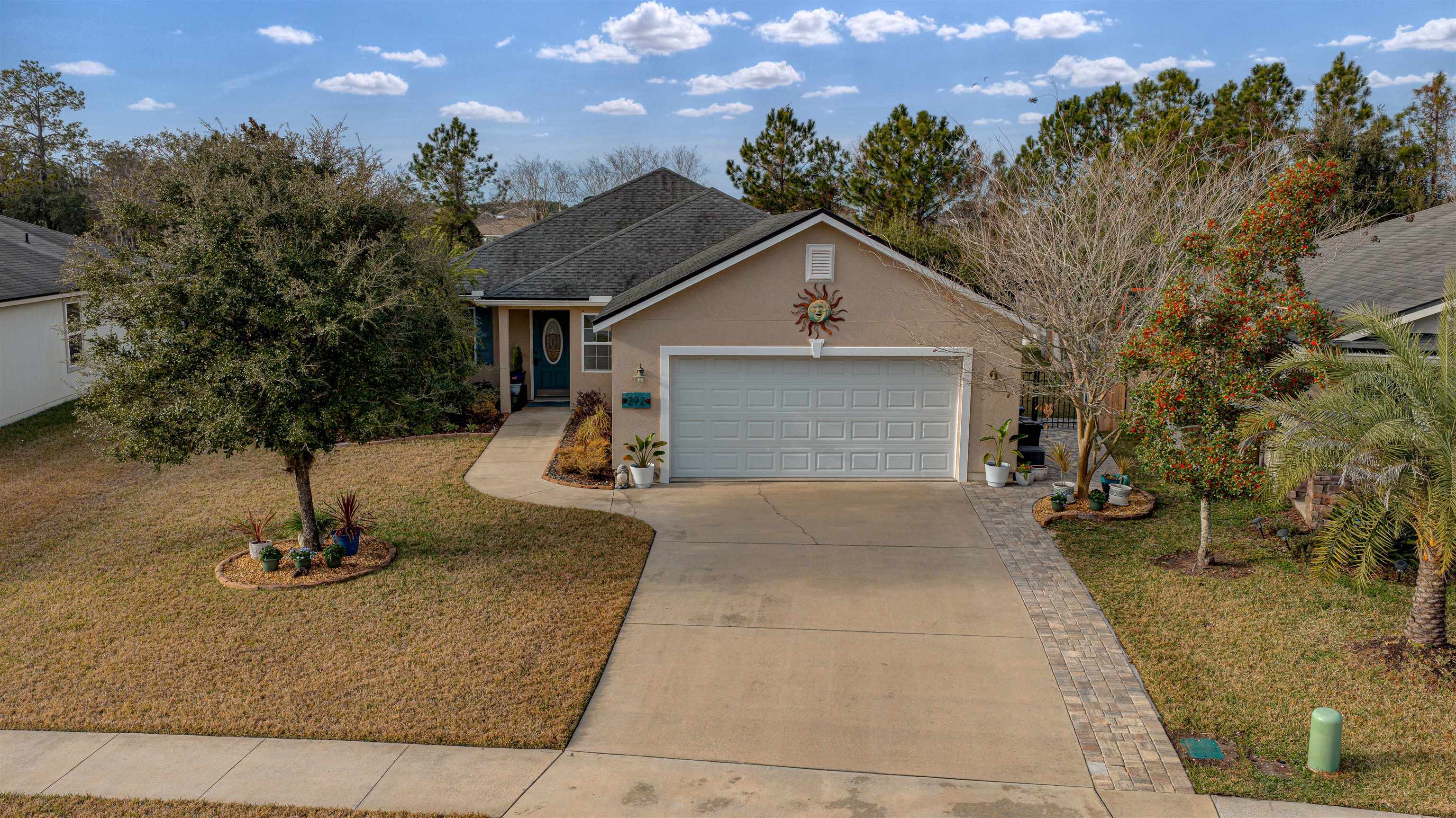 292 North Twin Maple Road St. Augustine, FL 32084 - Photo 5 of 79 View of front of home featuring stucco siding, a front yard, driveway, and a garage