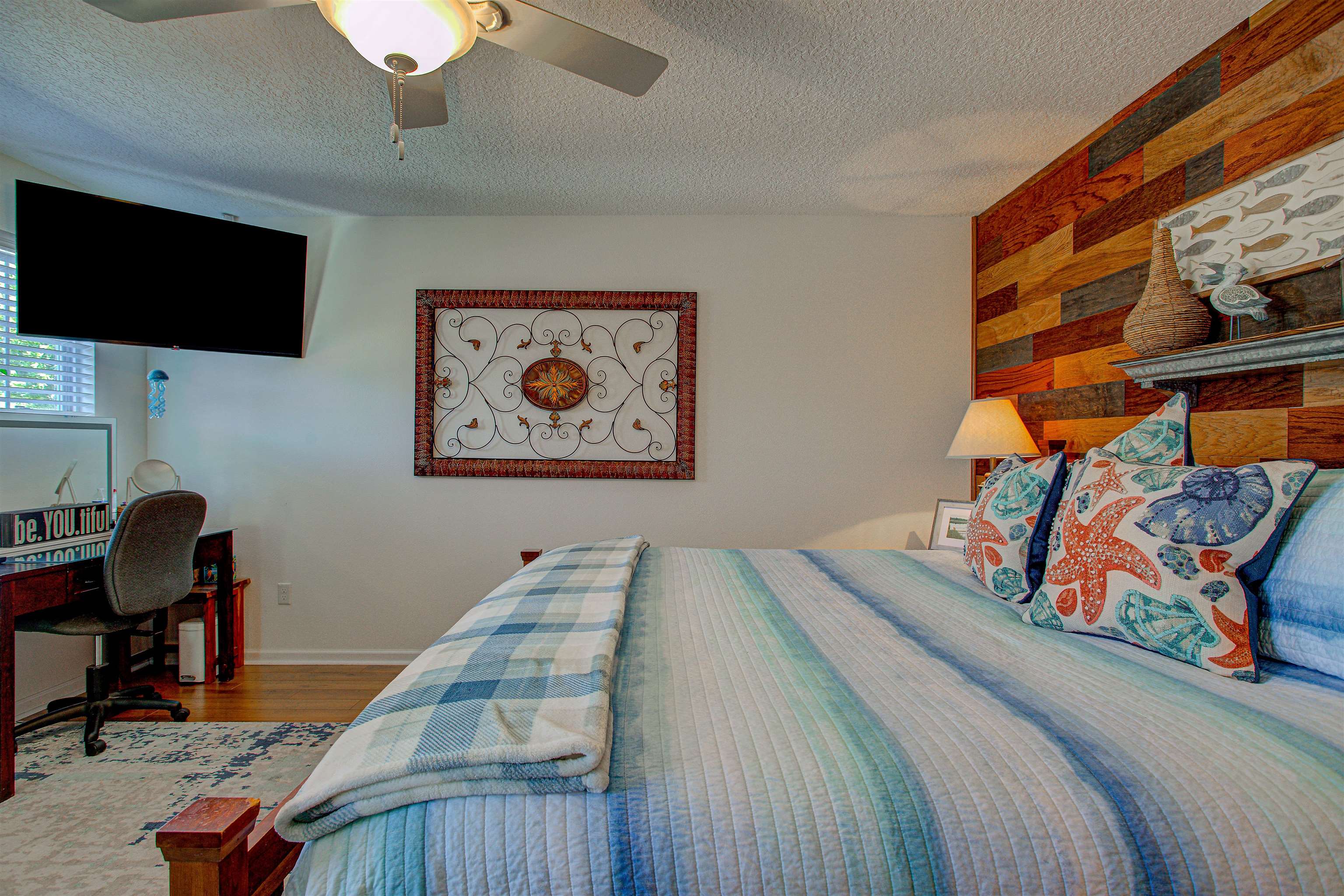 292 North Twin Maple Road St. Augustine, FL 32084 - Photo 54 of 79 Bedroom with a textured ceiling, wood finished floors, ceiling fan, and a desk