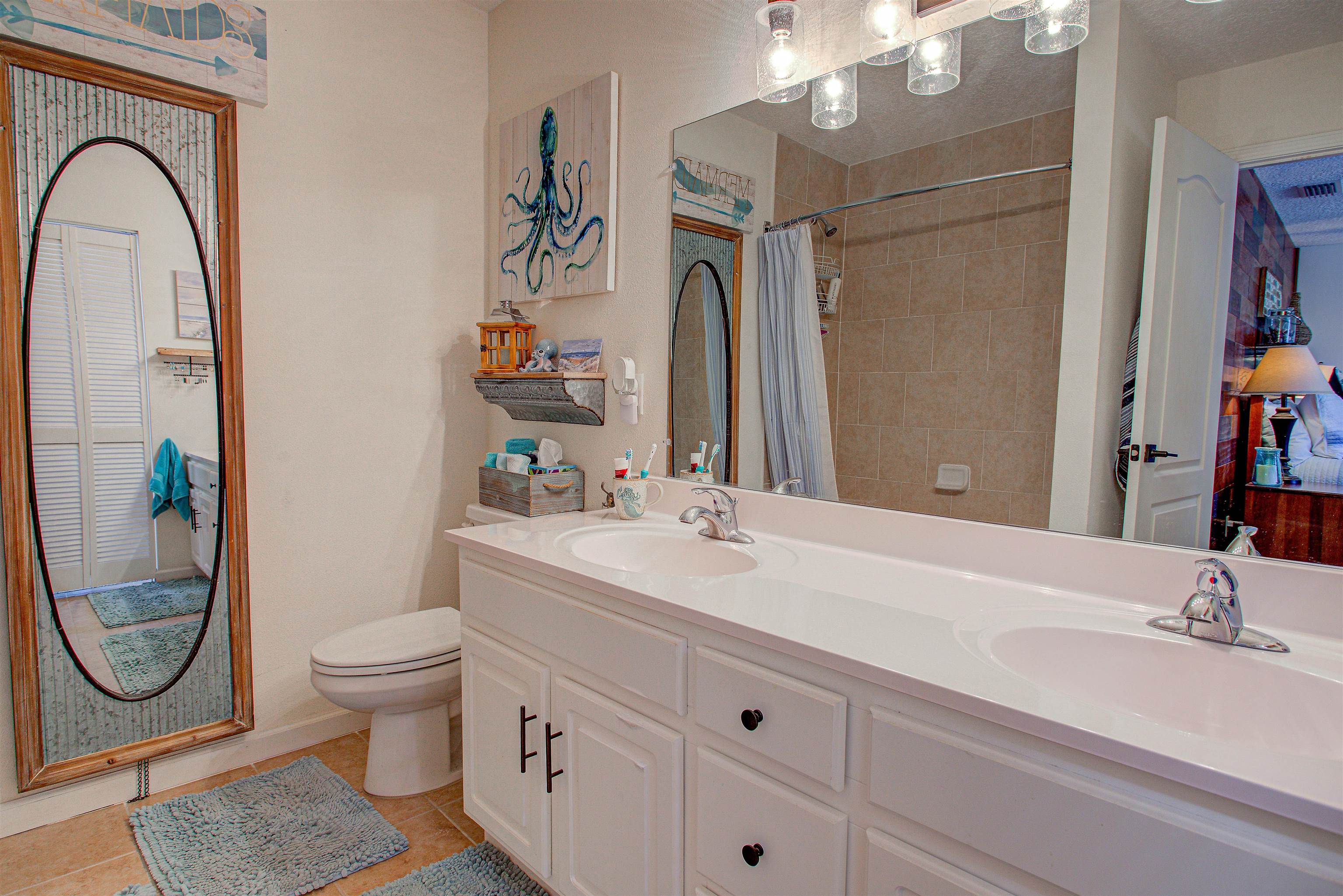 292 North Twin Maple Road St. Augustine, FL 32084 - Photo 56 of 79 a bathroom with a sink a toilet and a mirror