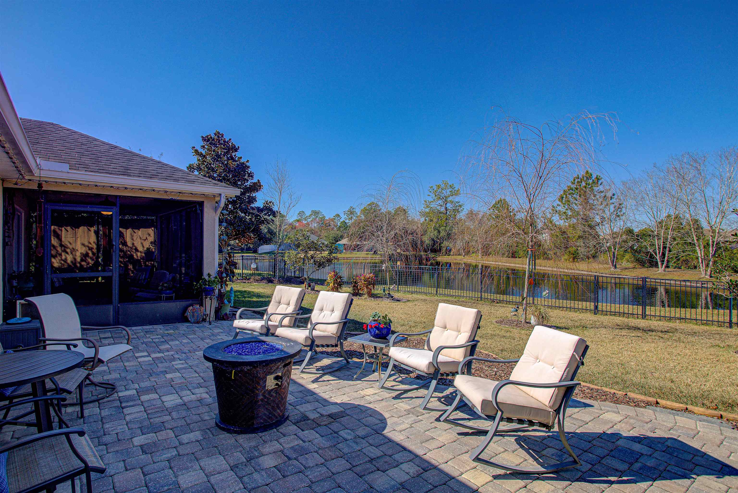 292 North Twin Maple Road St. Augustine, FL 32084 - Photo 66 of 79 Fenced backyard featuring a patio, an outdoor fire pit, a sunroom, and a water view