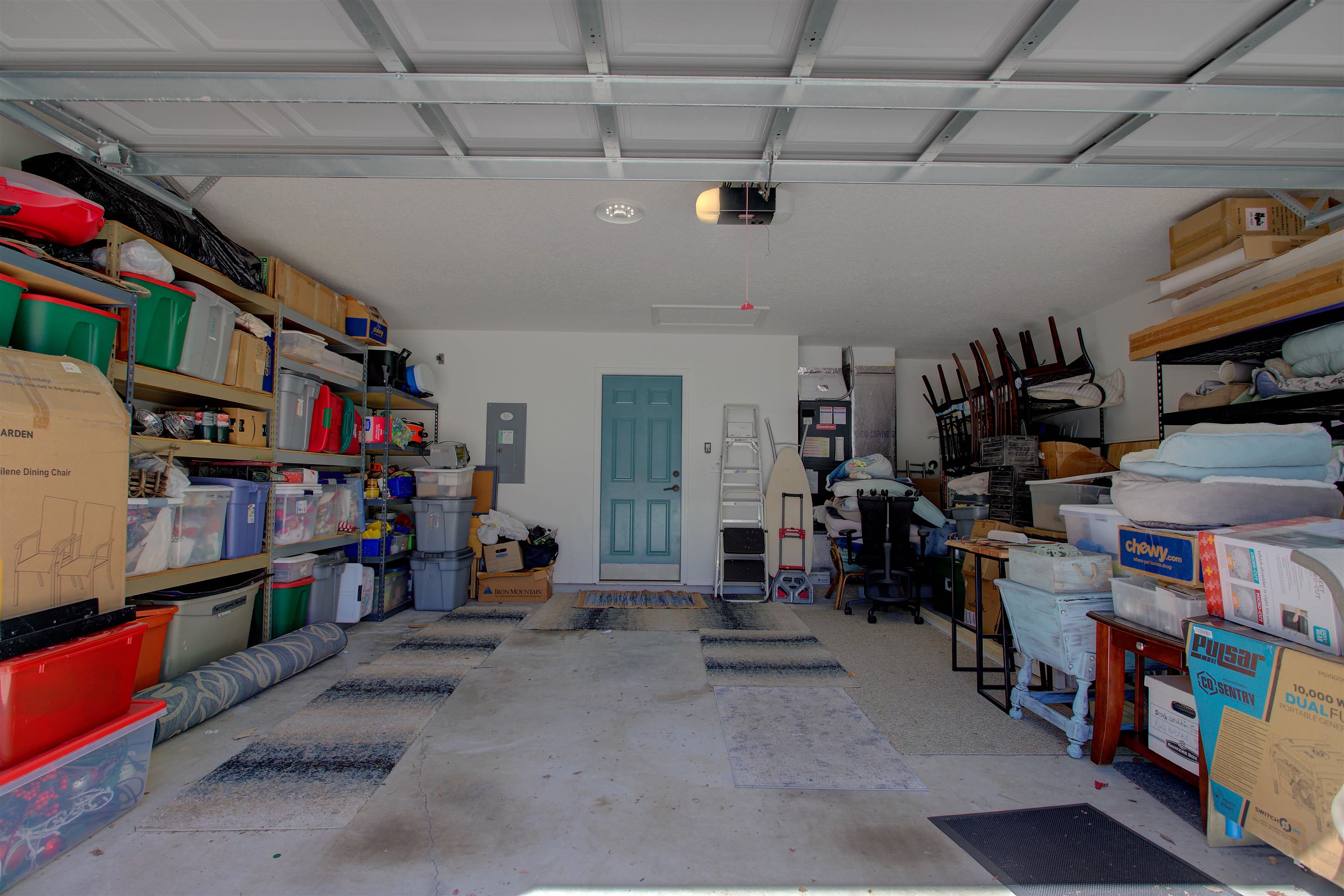292 North Twin Maple Road St. Augustine, FL 32084 - Photo 72 of 79 Garage featuring electric panel, heating unit, and a garage door opener