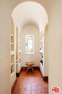 a kitchen with stainless steel appliances kitchen island granite countertop a sink a stove and a wooden floors