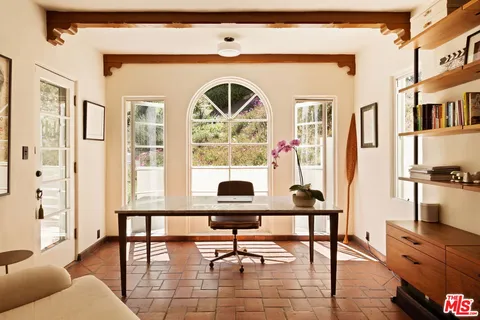 a outdoor dining room with furniture window and wooden floor