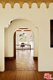 an outdoor space with furniture and wooden floor