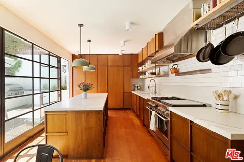 a spacious bedroom with a bed and wooden floor