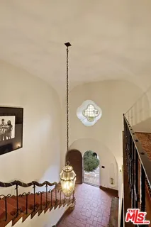 a bedroom with a bed and dresser with mirror